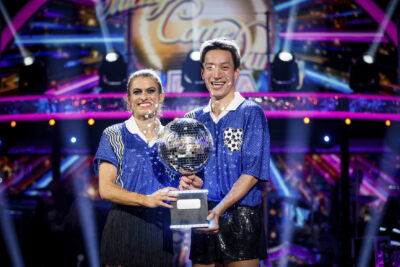 Karen and Carlos lift the glitterball trophy