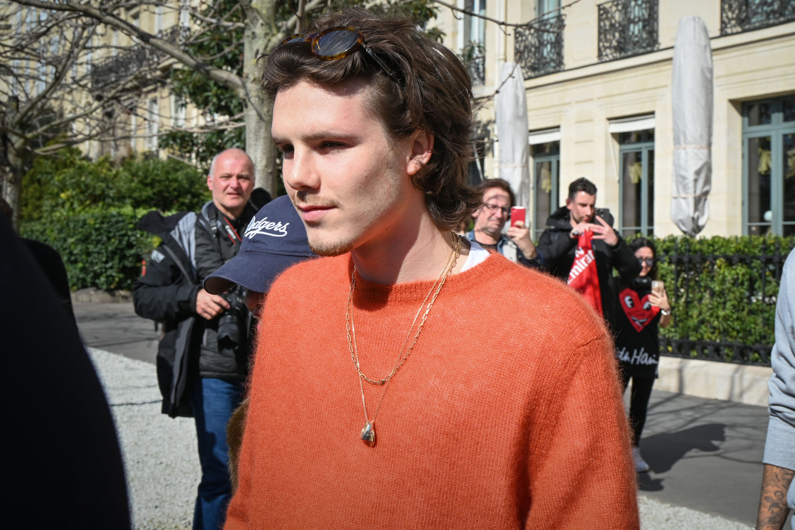 Cruz Beckham in an orange jumper 