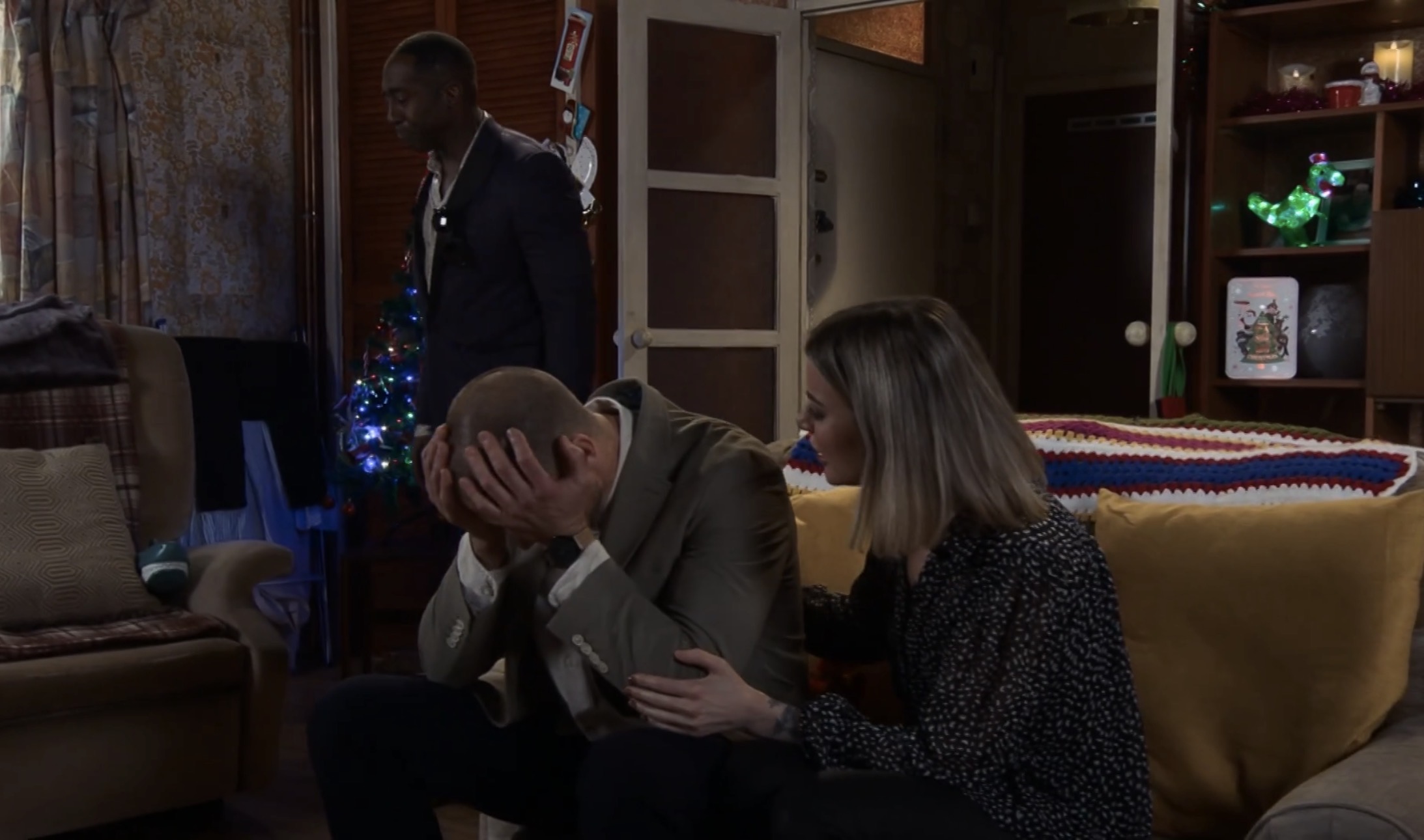 Coronation Street's Carl with his head in his hands, comforted by Abi