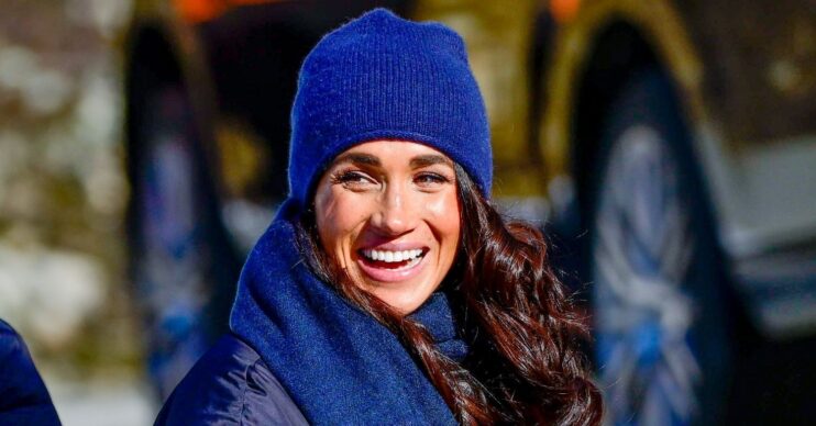 Meghan Markle smiling blue beanie and scarf