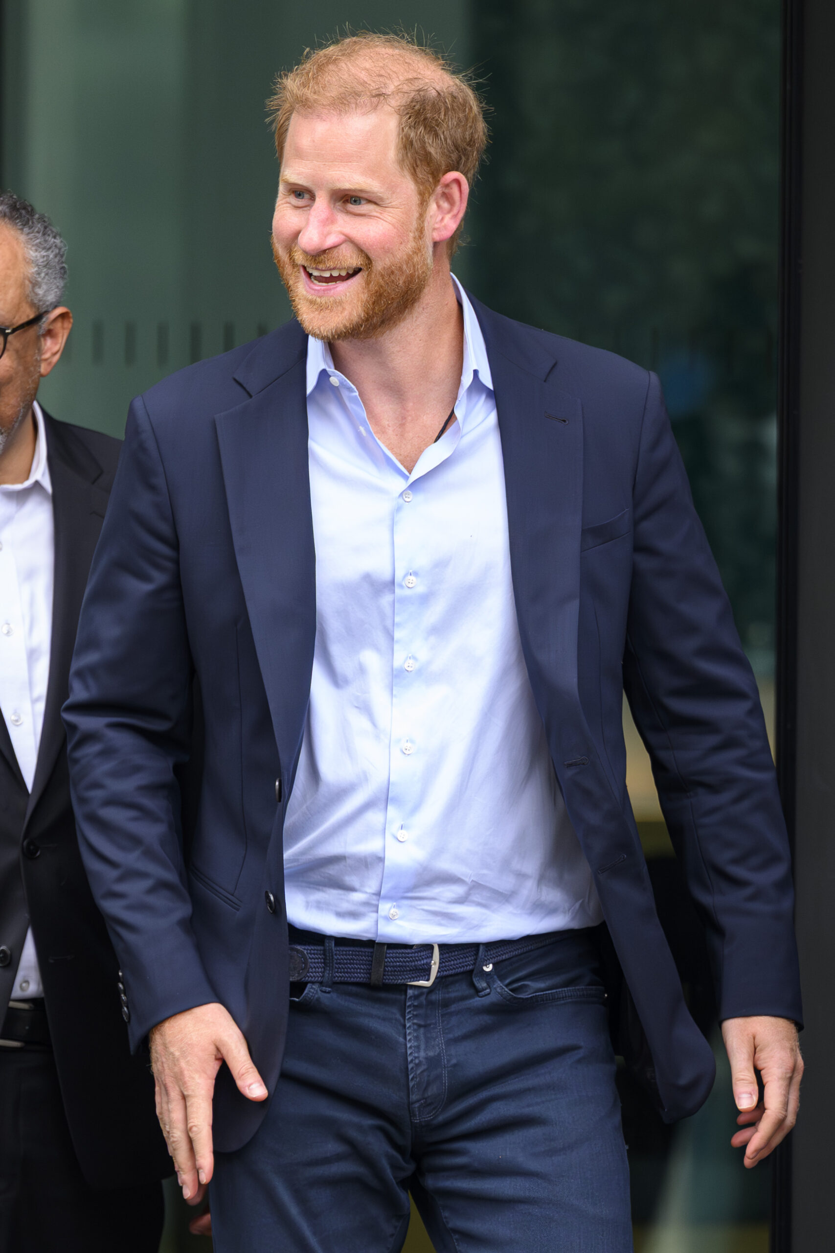 Prince Harry smiling and walking