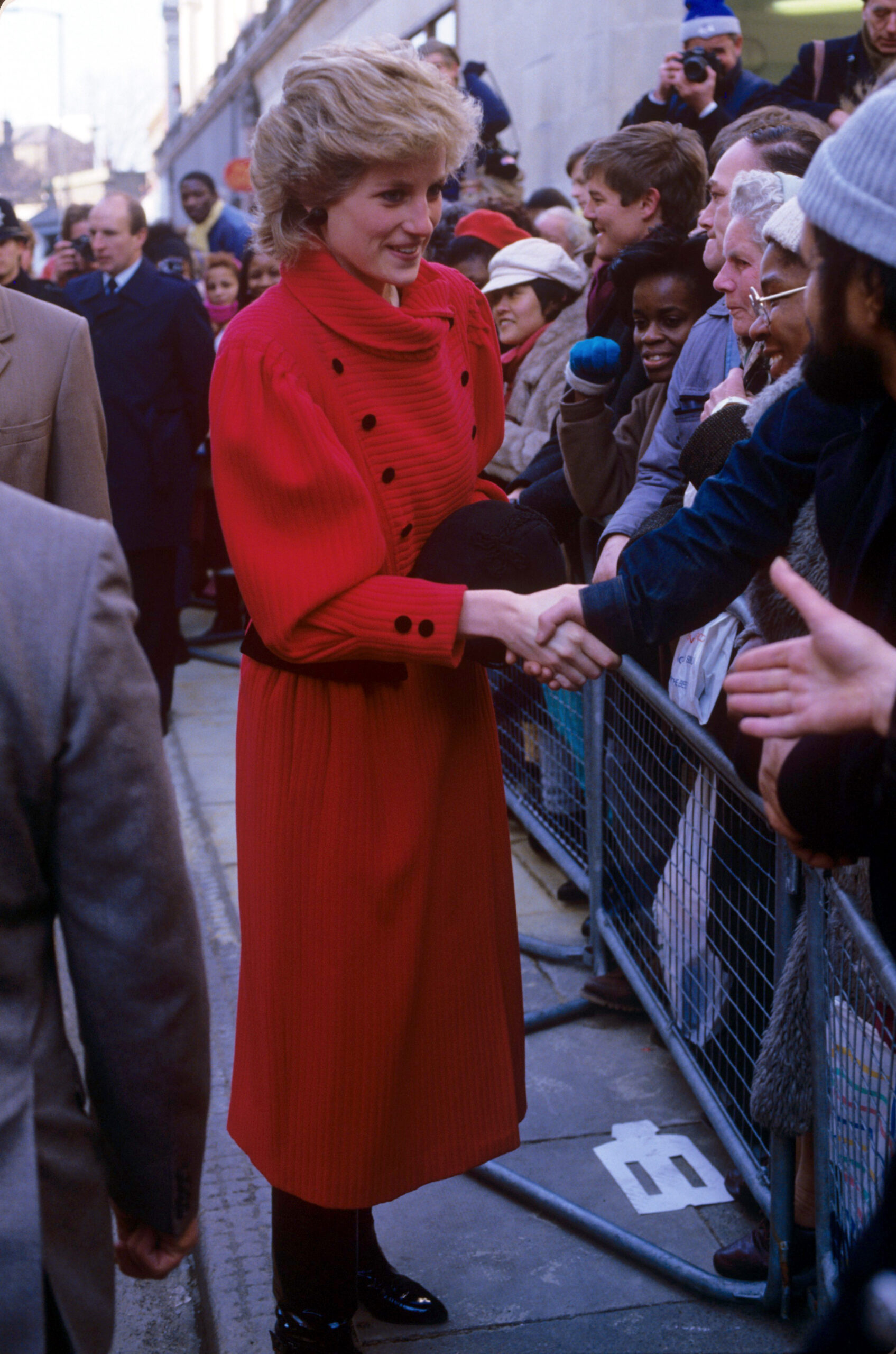 Princess Diana in red coat during royal engagement