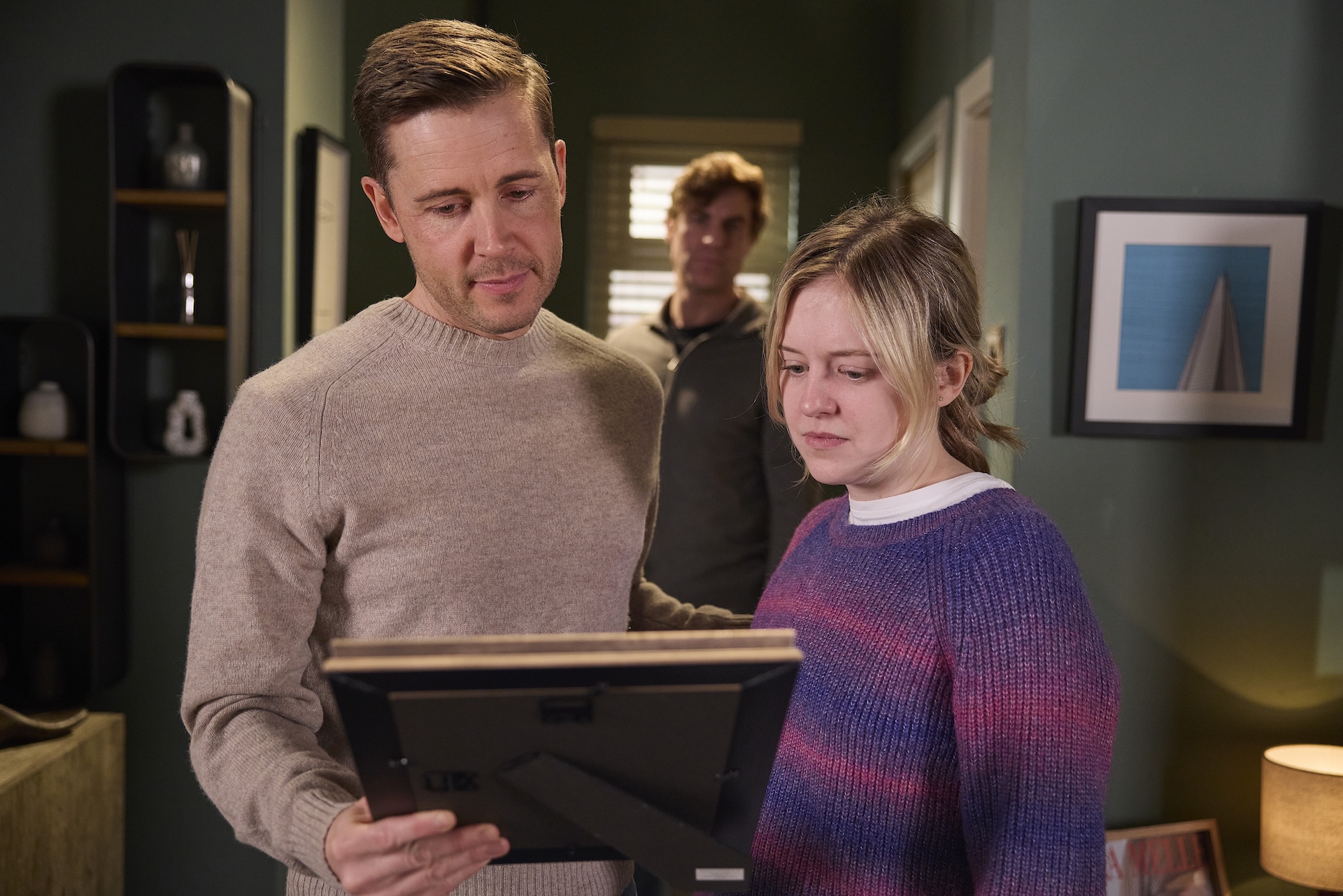 Todd and Summer looking at photo