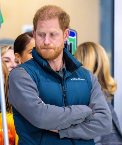 Prince Harry with folded arms, biting his lip
