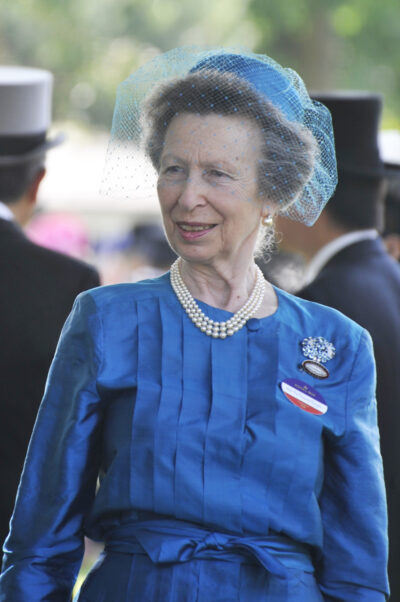 Princess Anne smiling wearing a blue ensemble