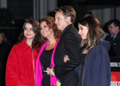 Nadia and husband Mark with their children at events