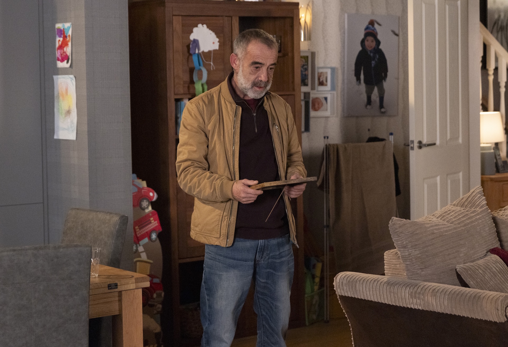 Coronation Street's Kevin staring at a photo