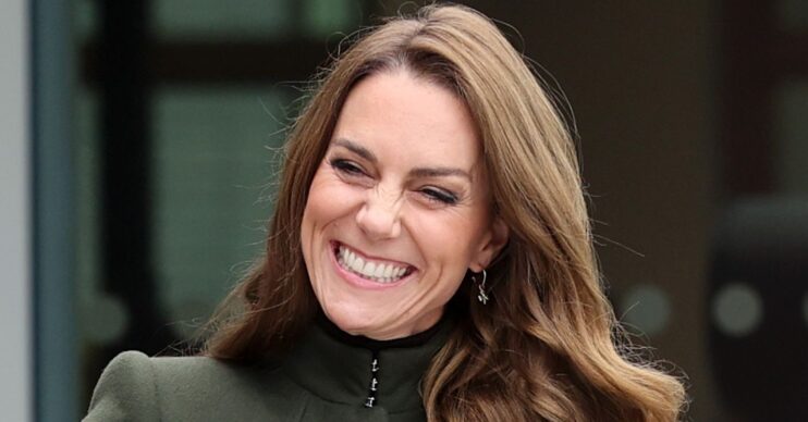 Princess of Wales smiling in green coat at royal engagement