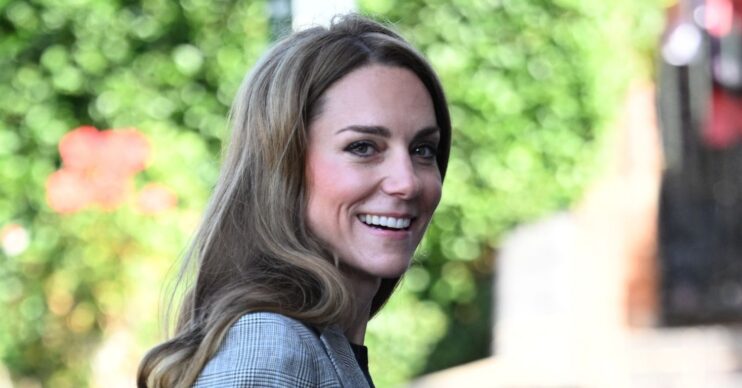 Kate Middleton smiling in grey suit