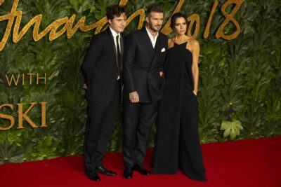 Victoria, David and Brooklyn Beckham at event