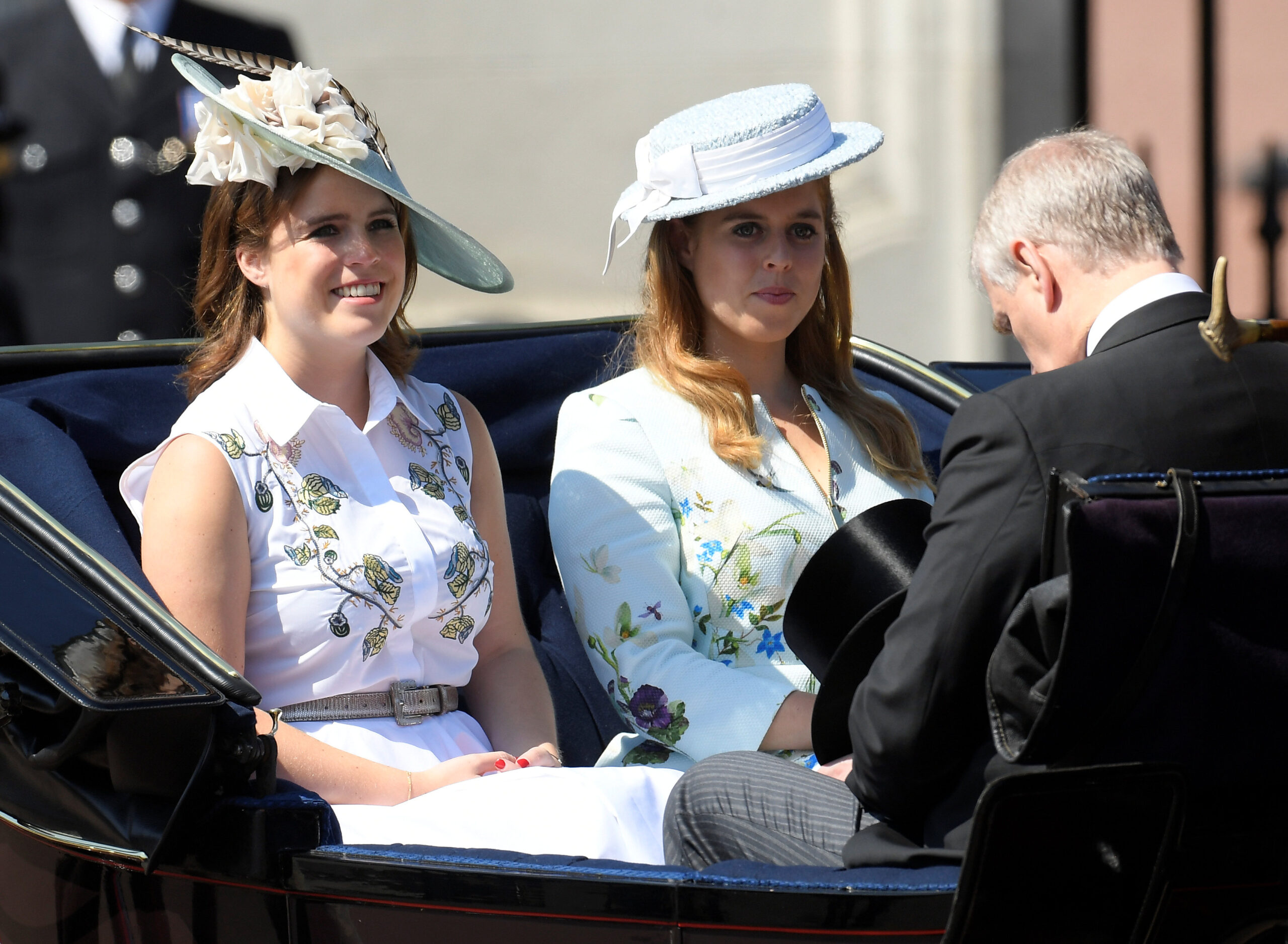 Princess Eugenie and Princess Beatrice riding in a carriage with Andrew Mountbatten-Windsor