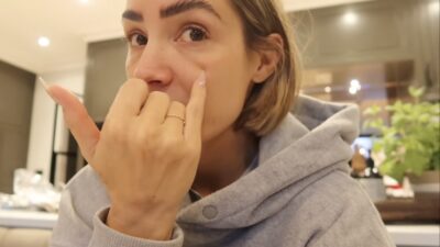 Frankie Bridge pointing to her face