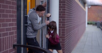 Izzy holding a door against Donte in Waterloo Road