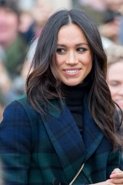 Meghan Markle smiling in tartan coat