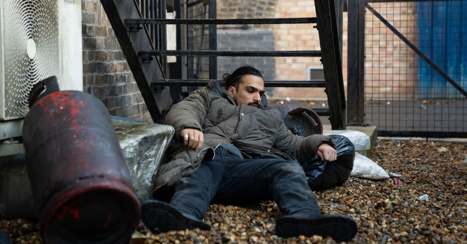 Ravi lying in rubbish in EastEnders