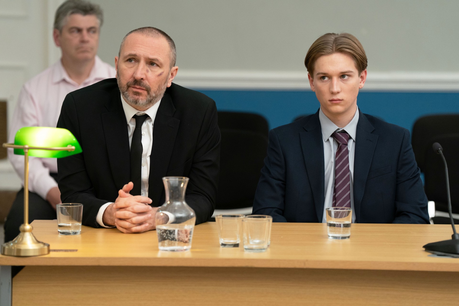 Joel sitting next to Ross in court 