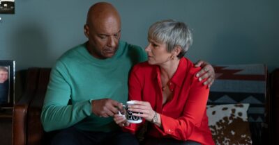 Nicola and George on the sofa with a cup of tea