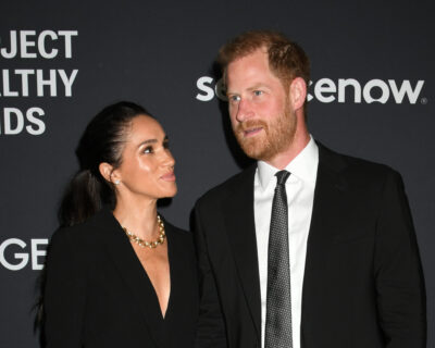 Meghan Markle looking up and smiling at Prince Harry