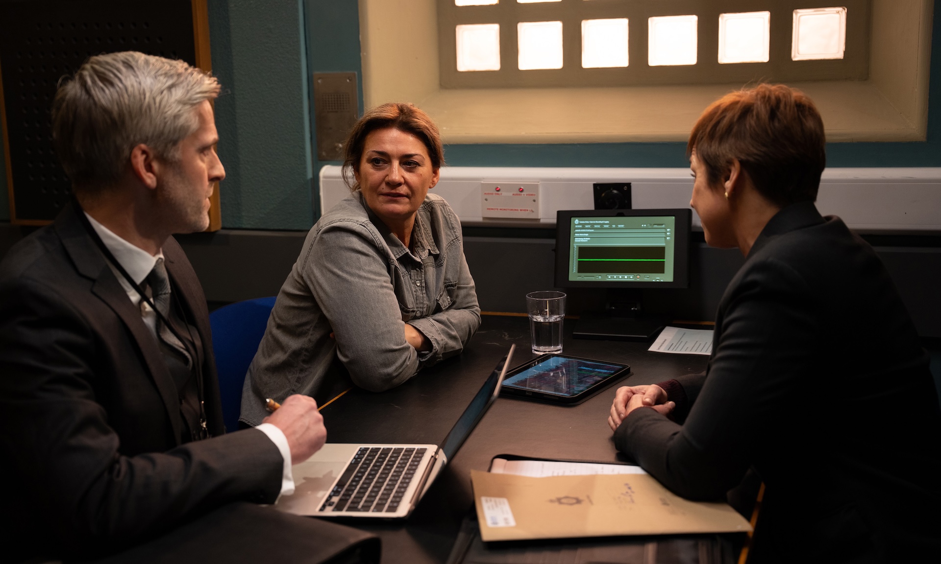 Moira looks at her solicitor during an interview with DS Walsh in Emmerdale spoilers