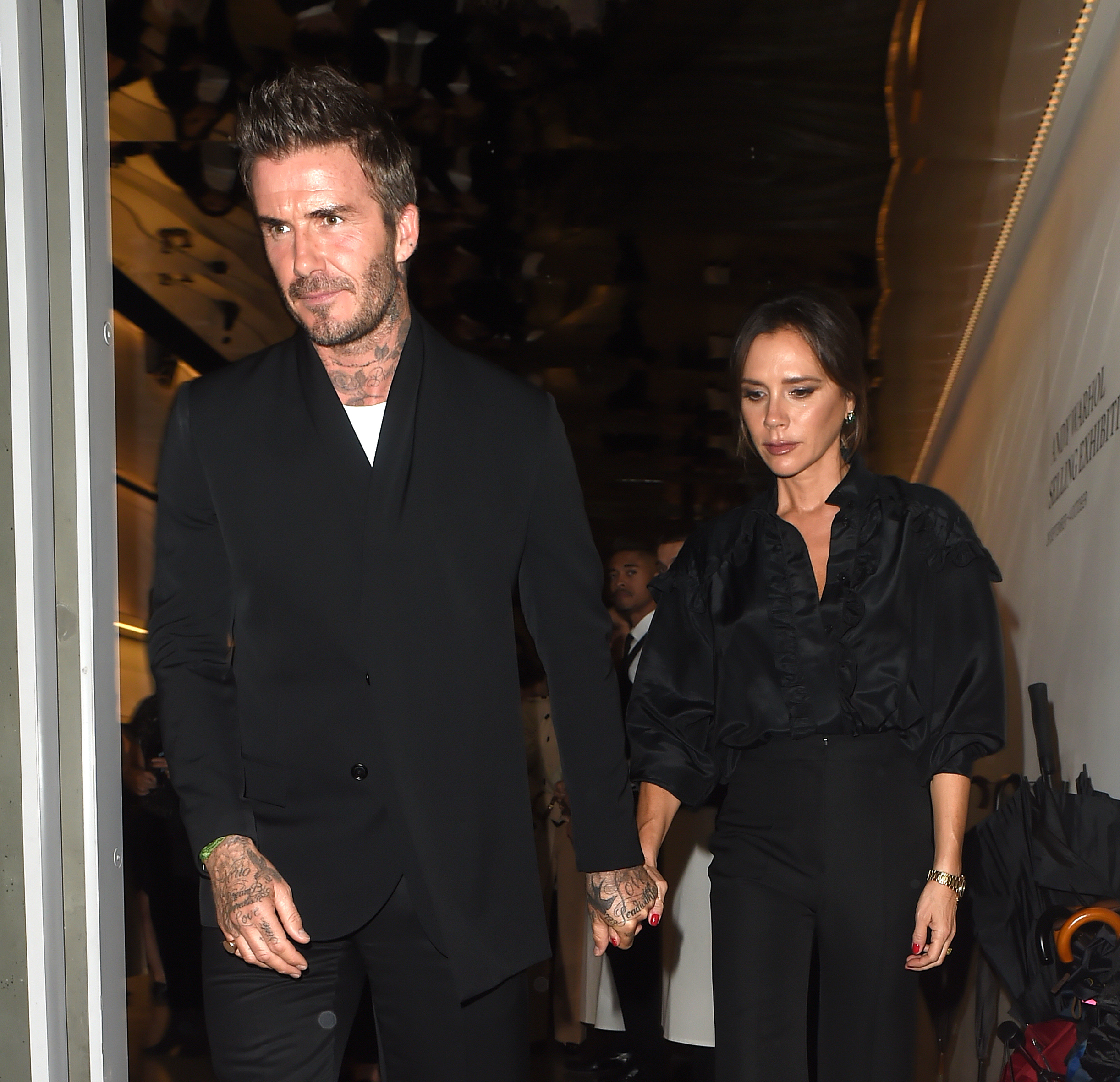 David and Victoria Beckham walking outside 