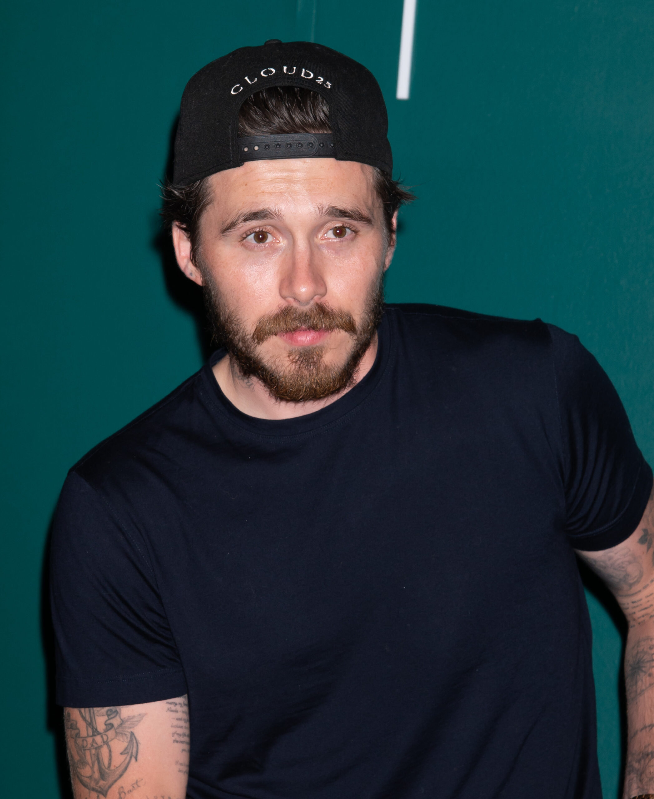 Brooklyn Beckham wearing hat at event