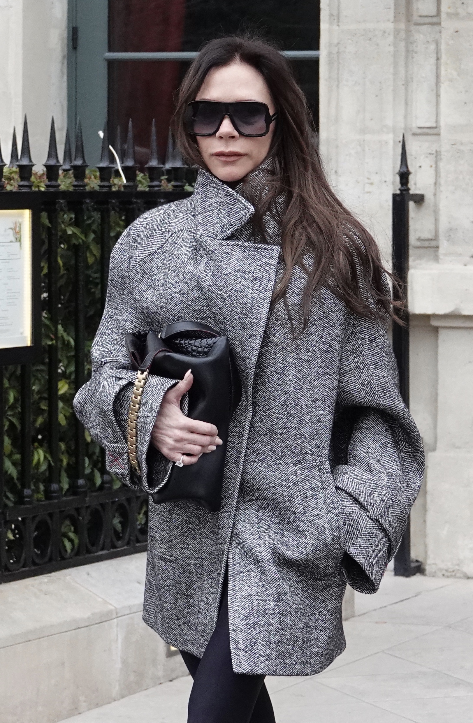 Victoria Beckham in a coat and sunglasses