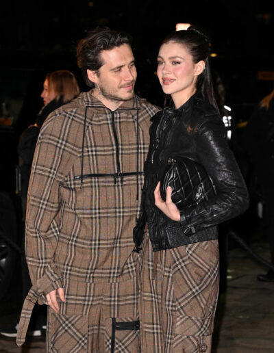 Nicola and Brooklyn smiling at each other at an event