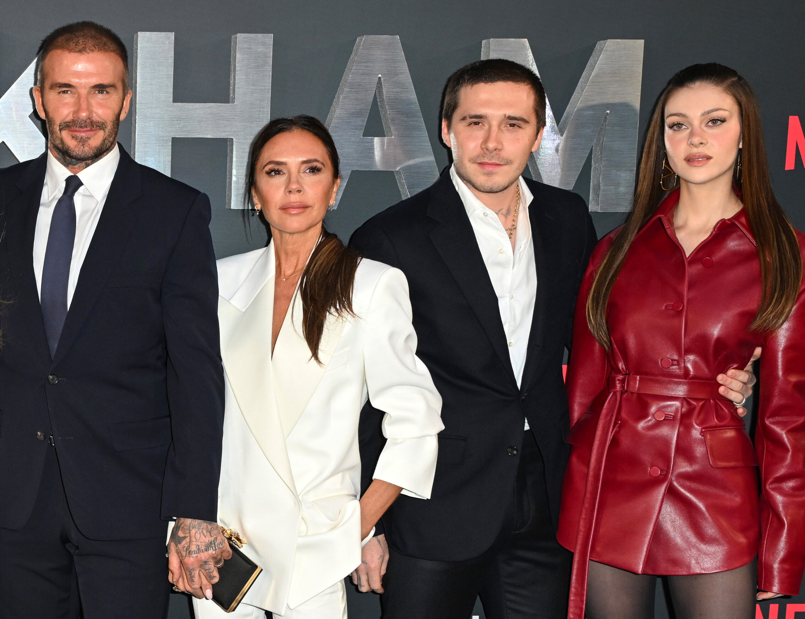 The Beckhams and Nicola at an event 