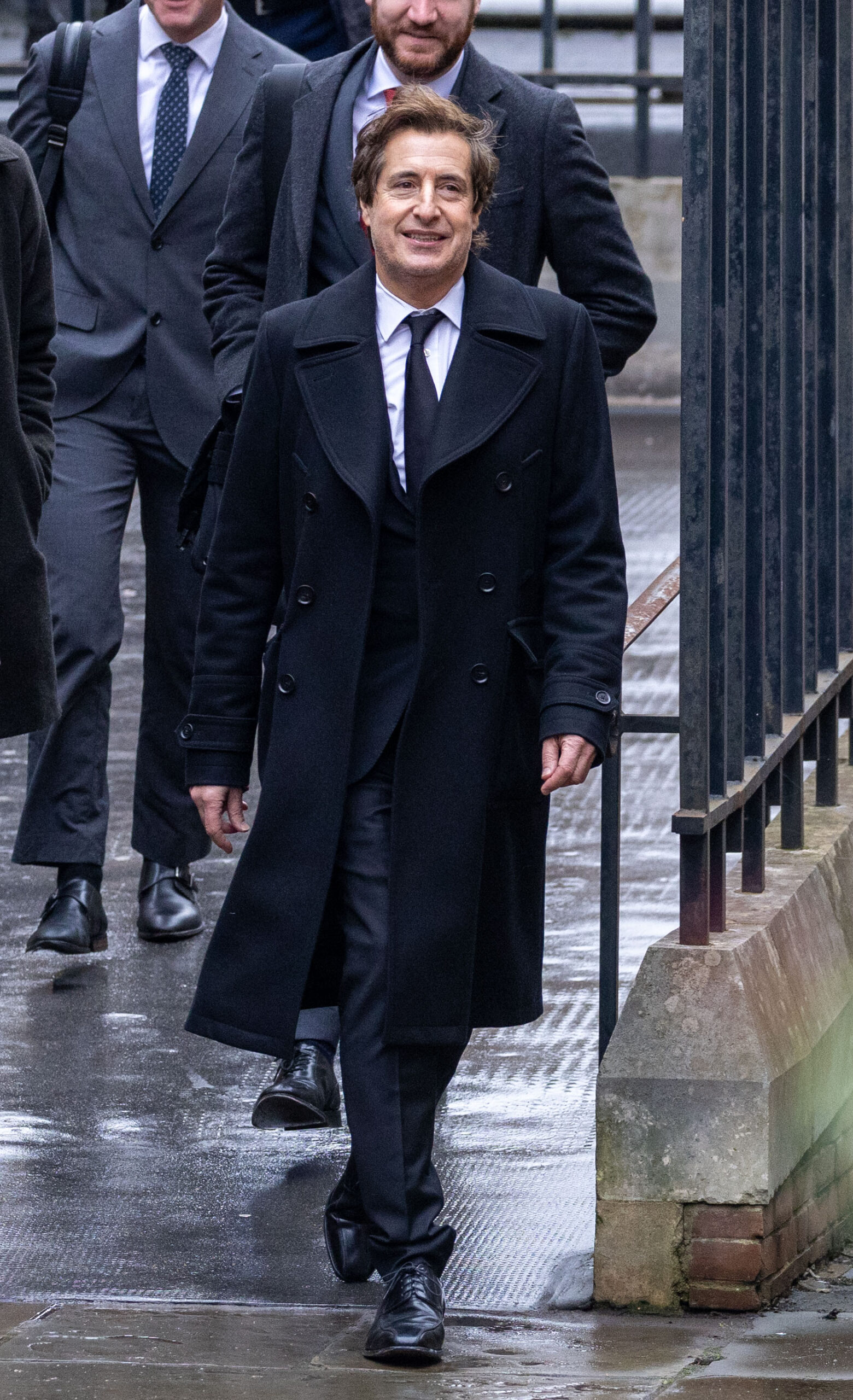 David Sherborne wearing a long coat as he walks into High Court