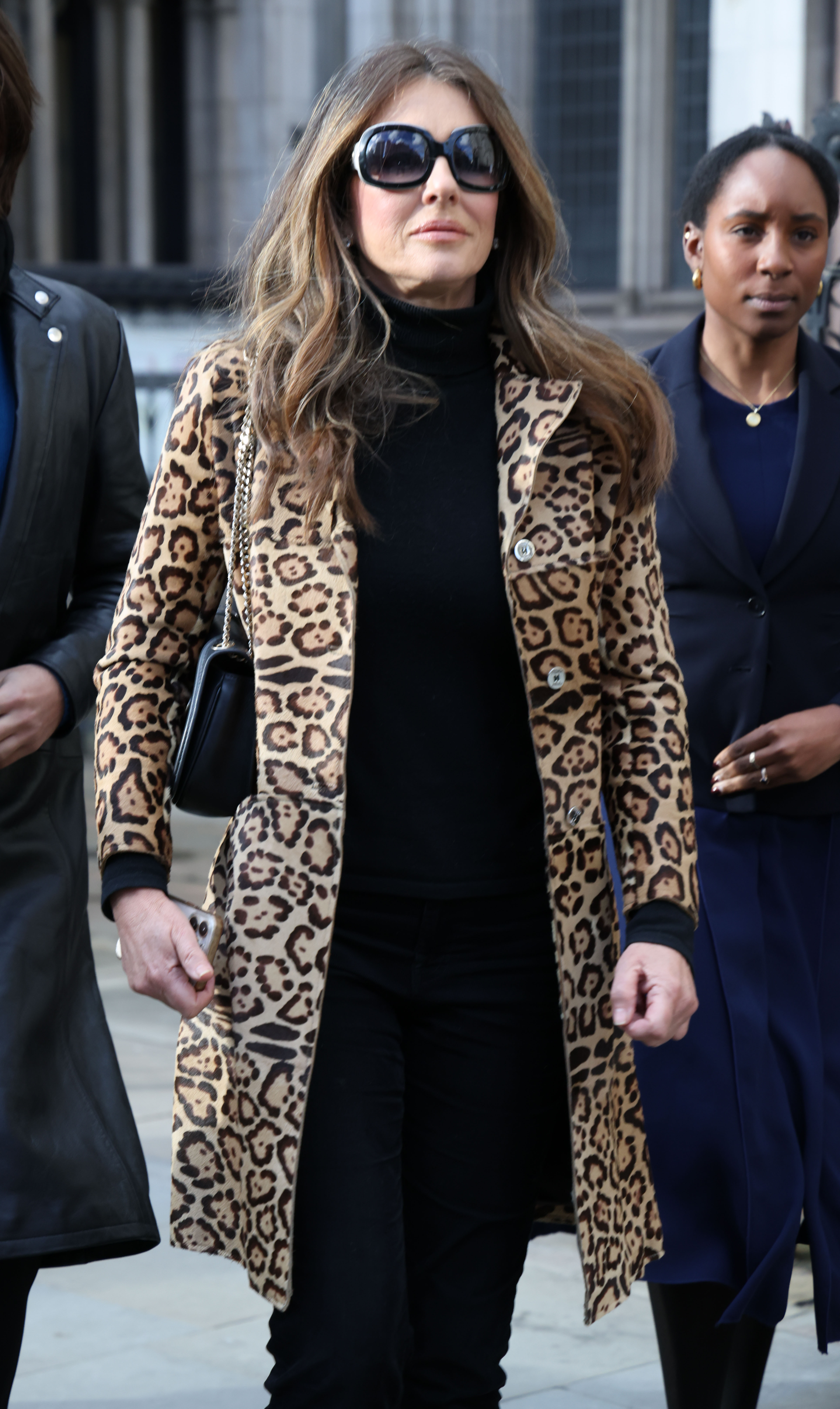 Elizabeth Hurley and Damian Hurley arrive at court during a court case against Associated Newspapers Ltd at The Royal Courts of Justice, Elizabeth wearing an animal print coat