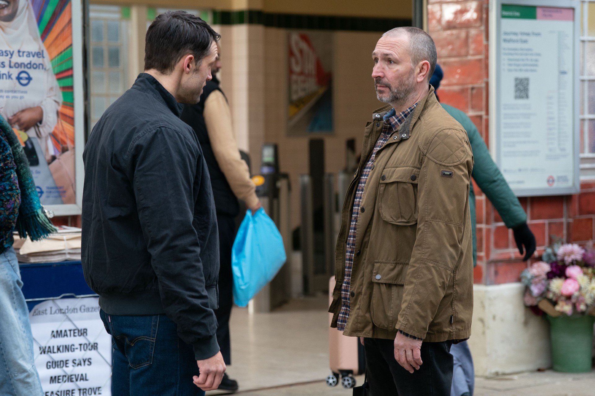 Ross and Mark standing outside the tube station talking 