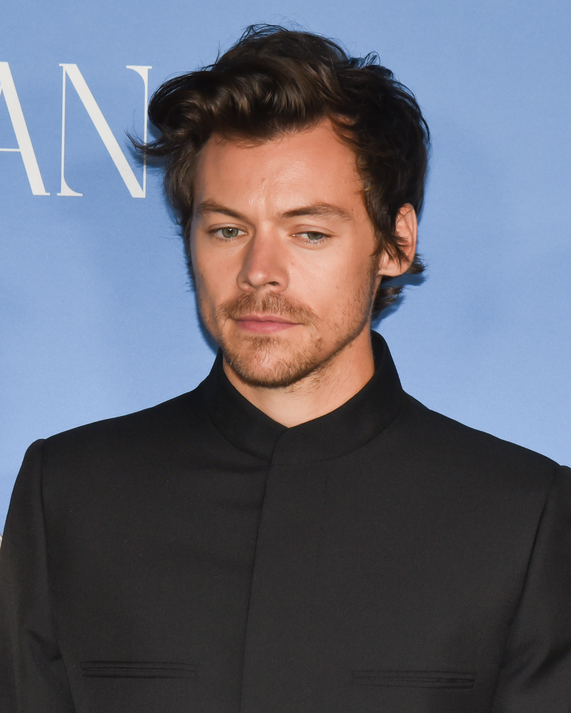 Harry Styles in black suit at an event