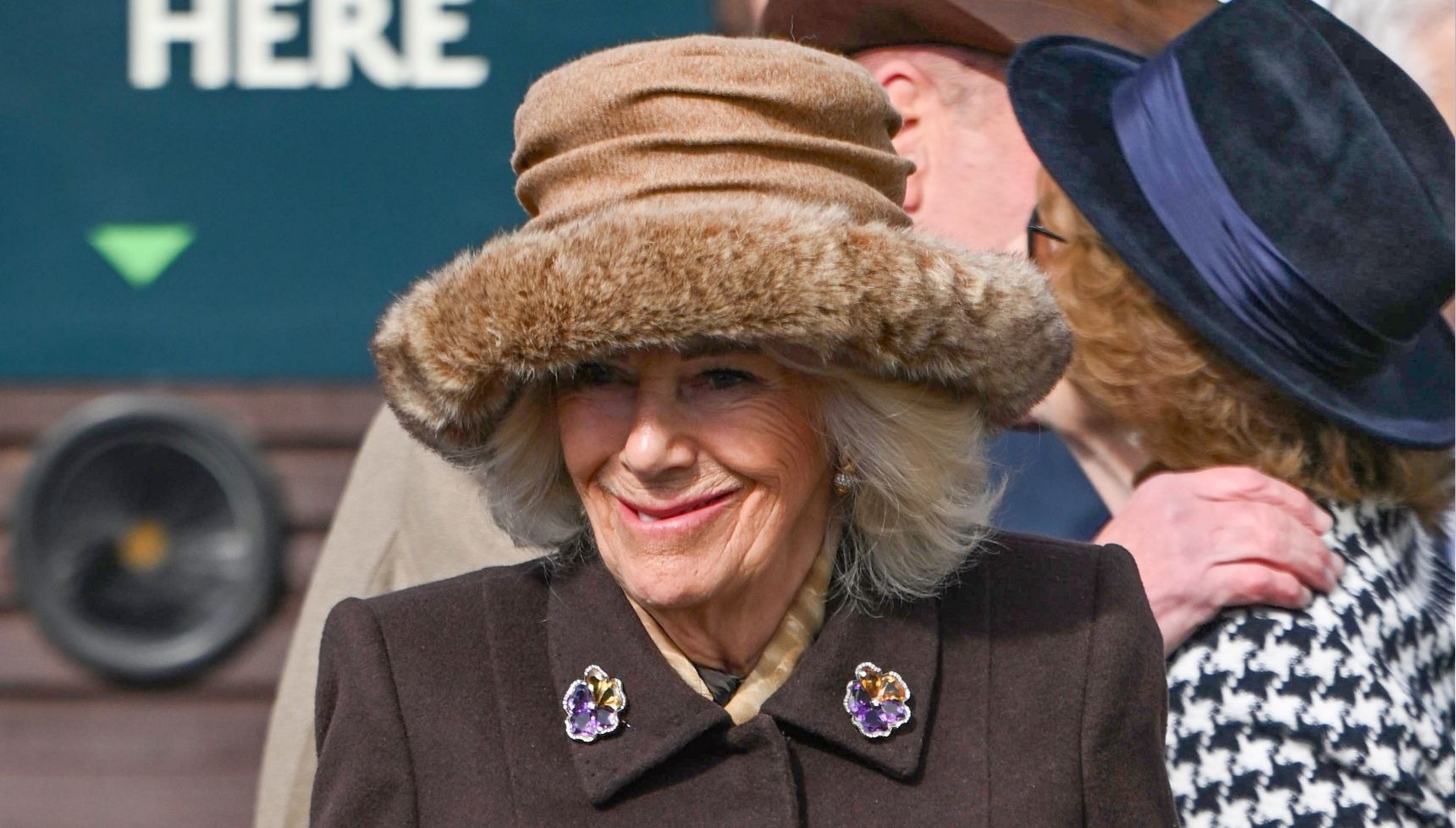 Queen Camilla in brown coat and fur hat