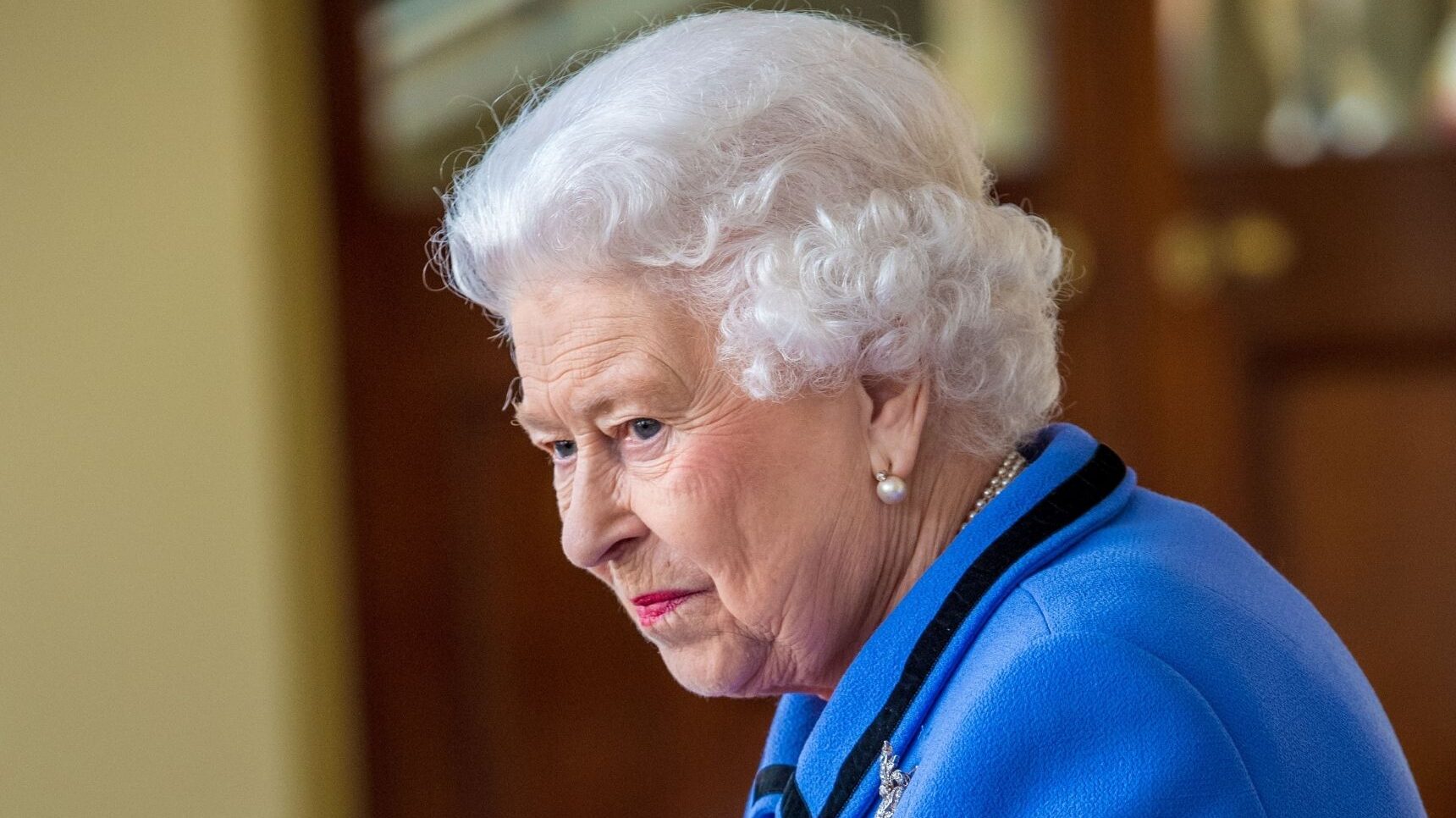 Queen Elizabeth looking down with a small smile