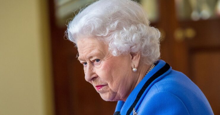 Queen Elizabeth looking down with a small smile