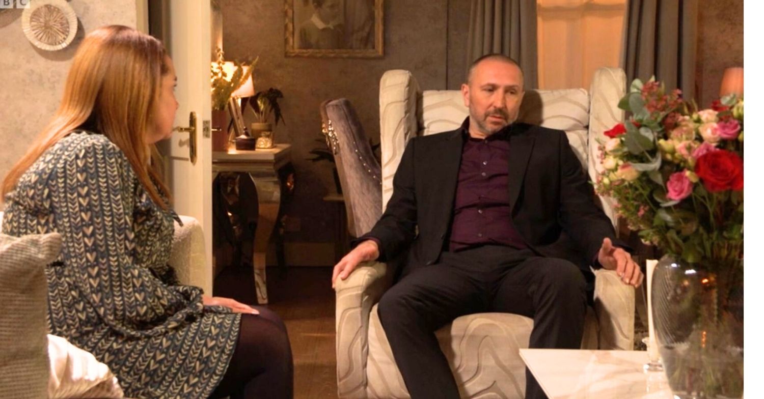 Vicky and Ross talking in the lounge at home in EastEnders 