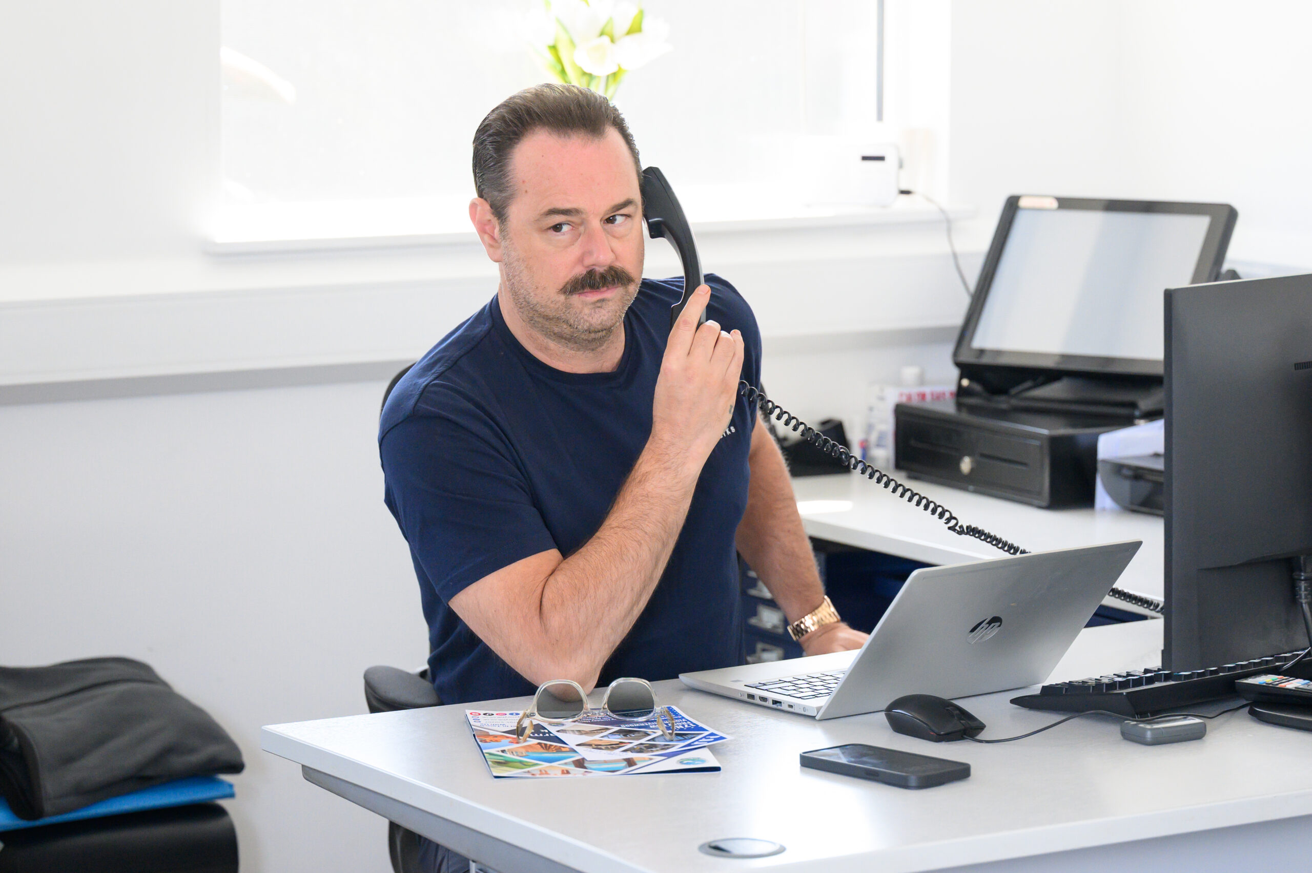 Danny Dyer on the phone at his caravan park