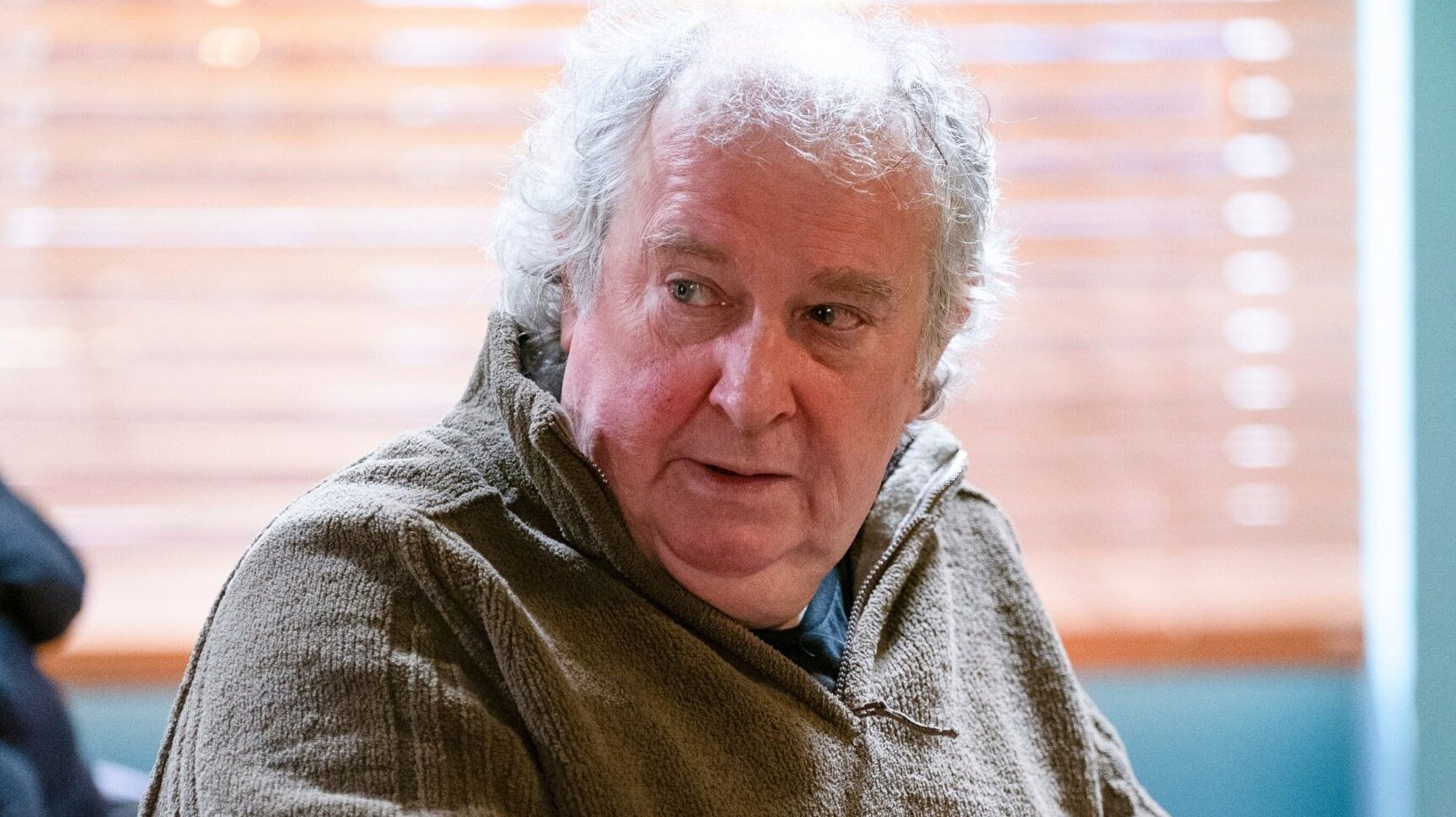 Nigel in EastEnders sitting in the cafe