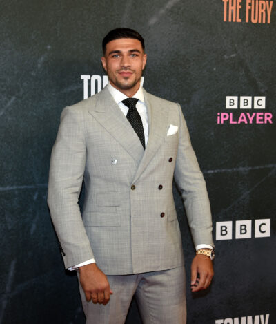 Tommy Fury in a grey suit
