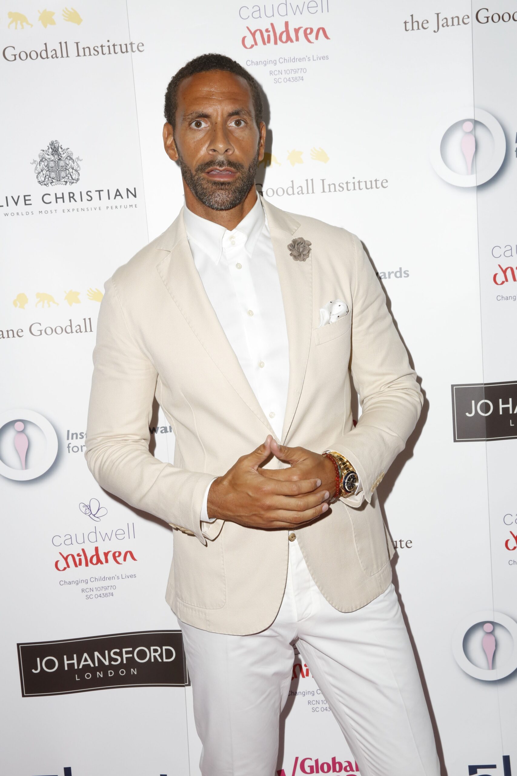 Rio Ferdinand wearing a cream jacket