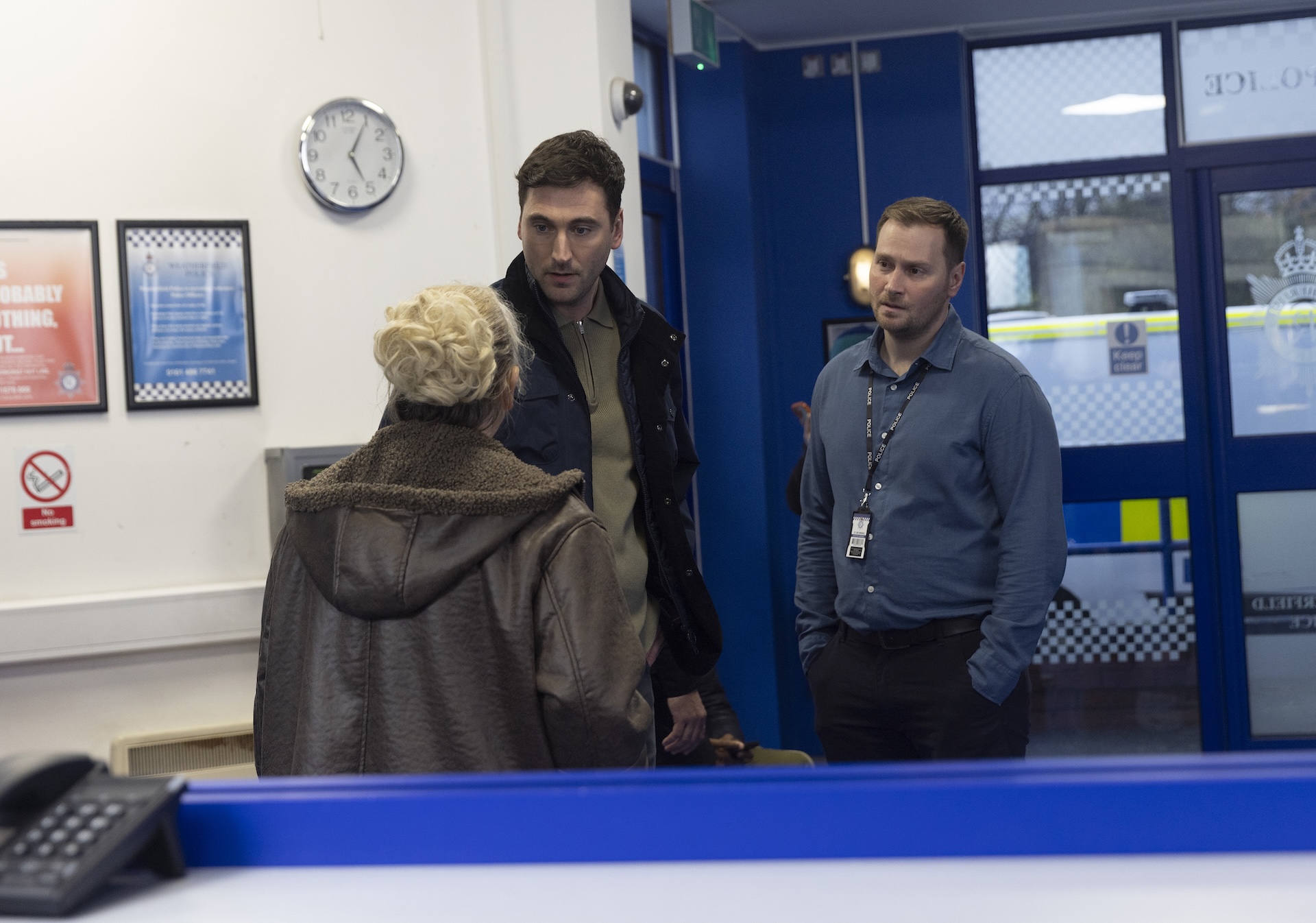 Bernie talking to Kit at police station