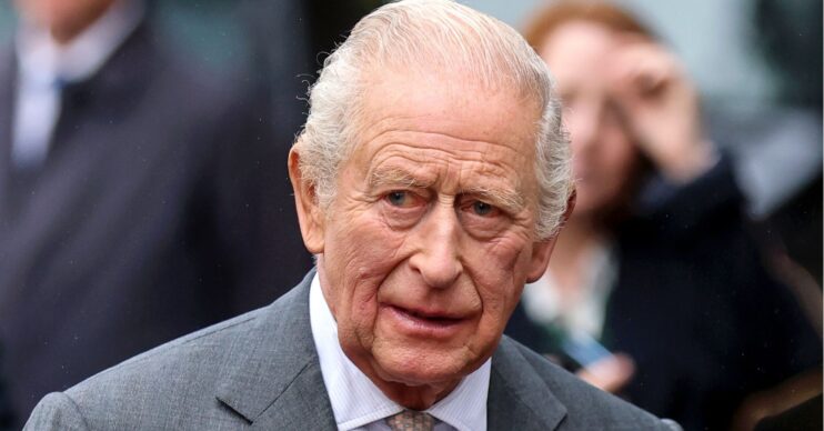 King Charles in grey suit, looking concerned