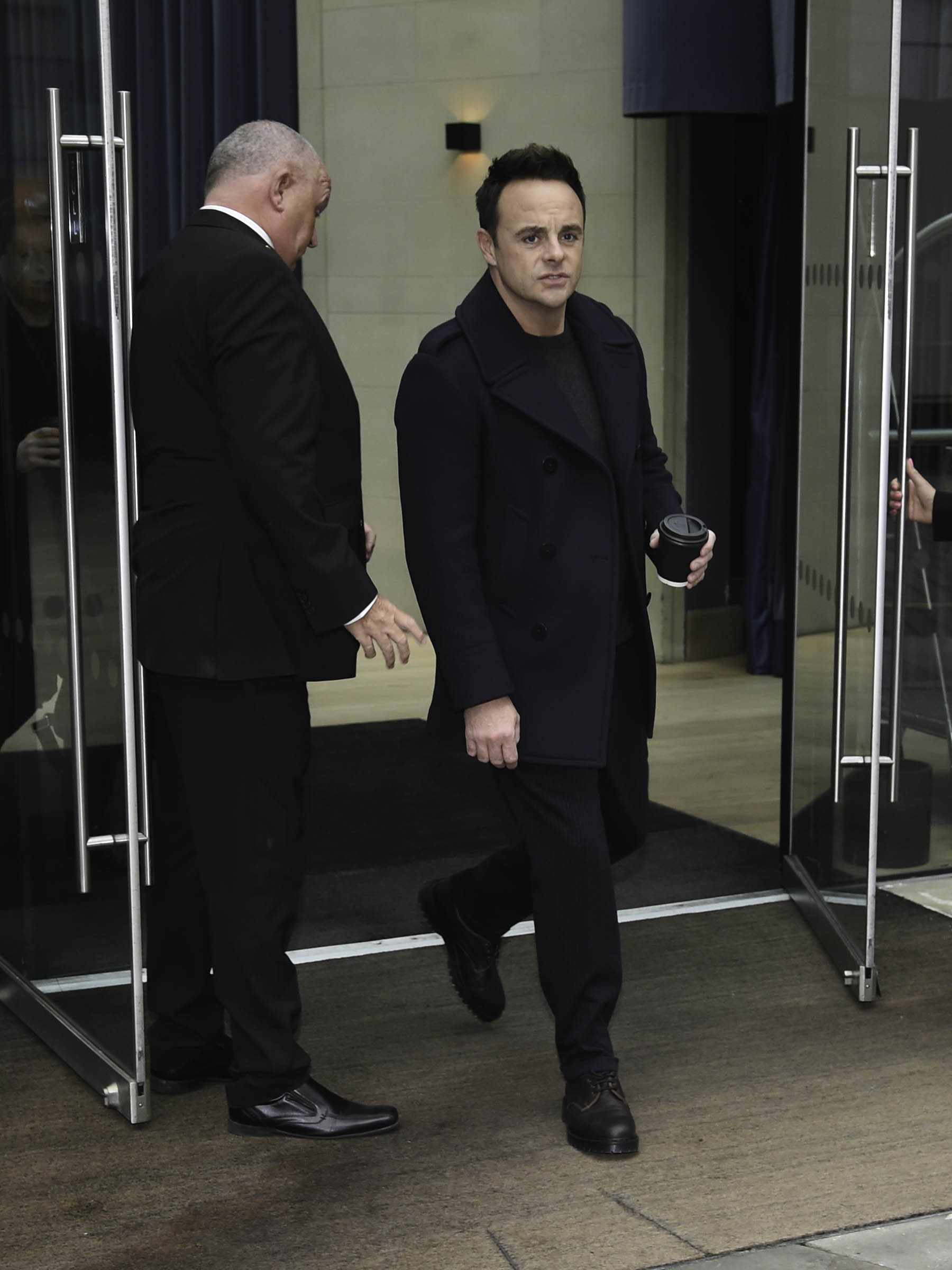 Ant McPartlin walking out of a hotel