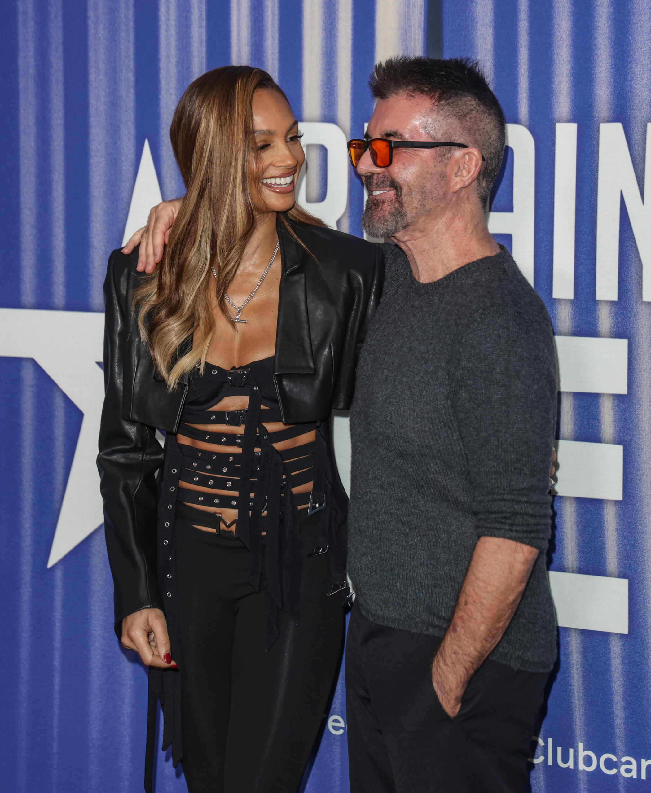 Alesha Dixon and Simon Cowell at an event together hugging