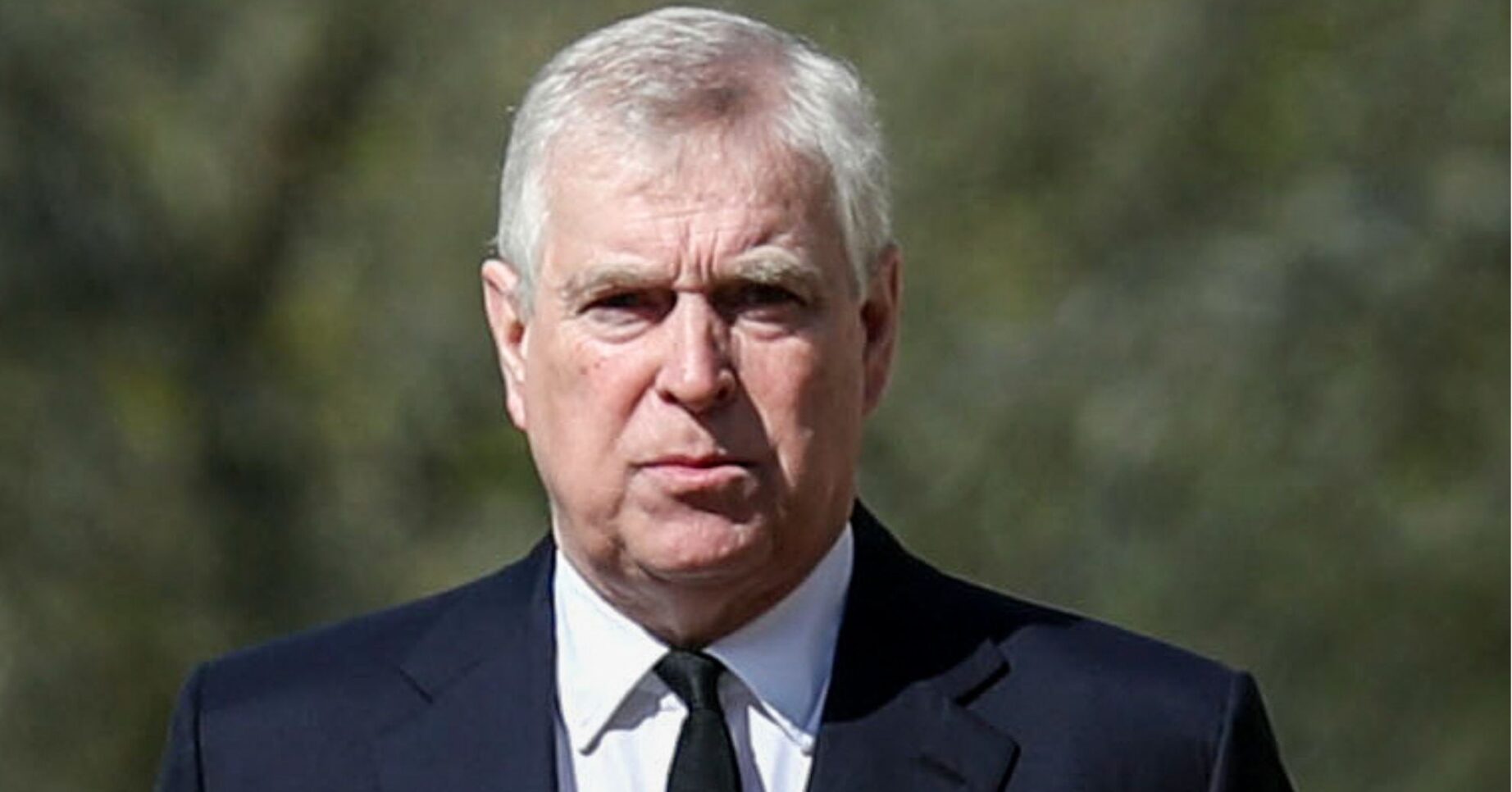 Andrew Mountbatten-Windsor looking serious in suit