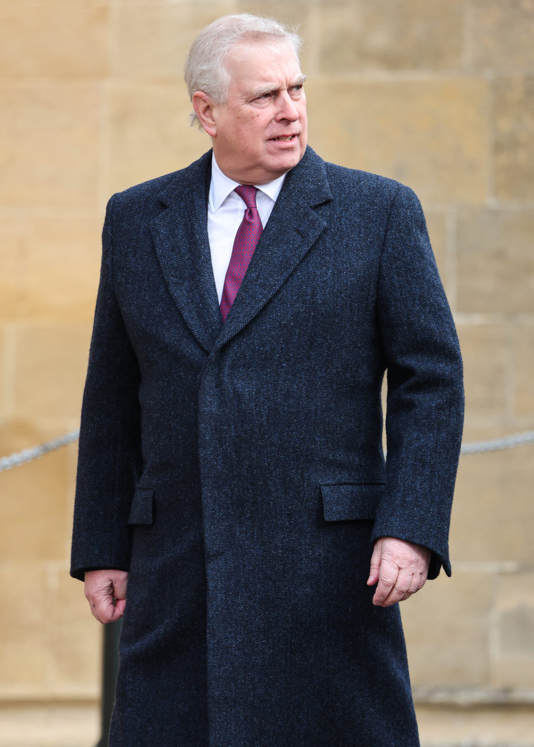 Andrew Mountbatten-Windsor frowning as he walks