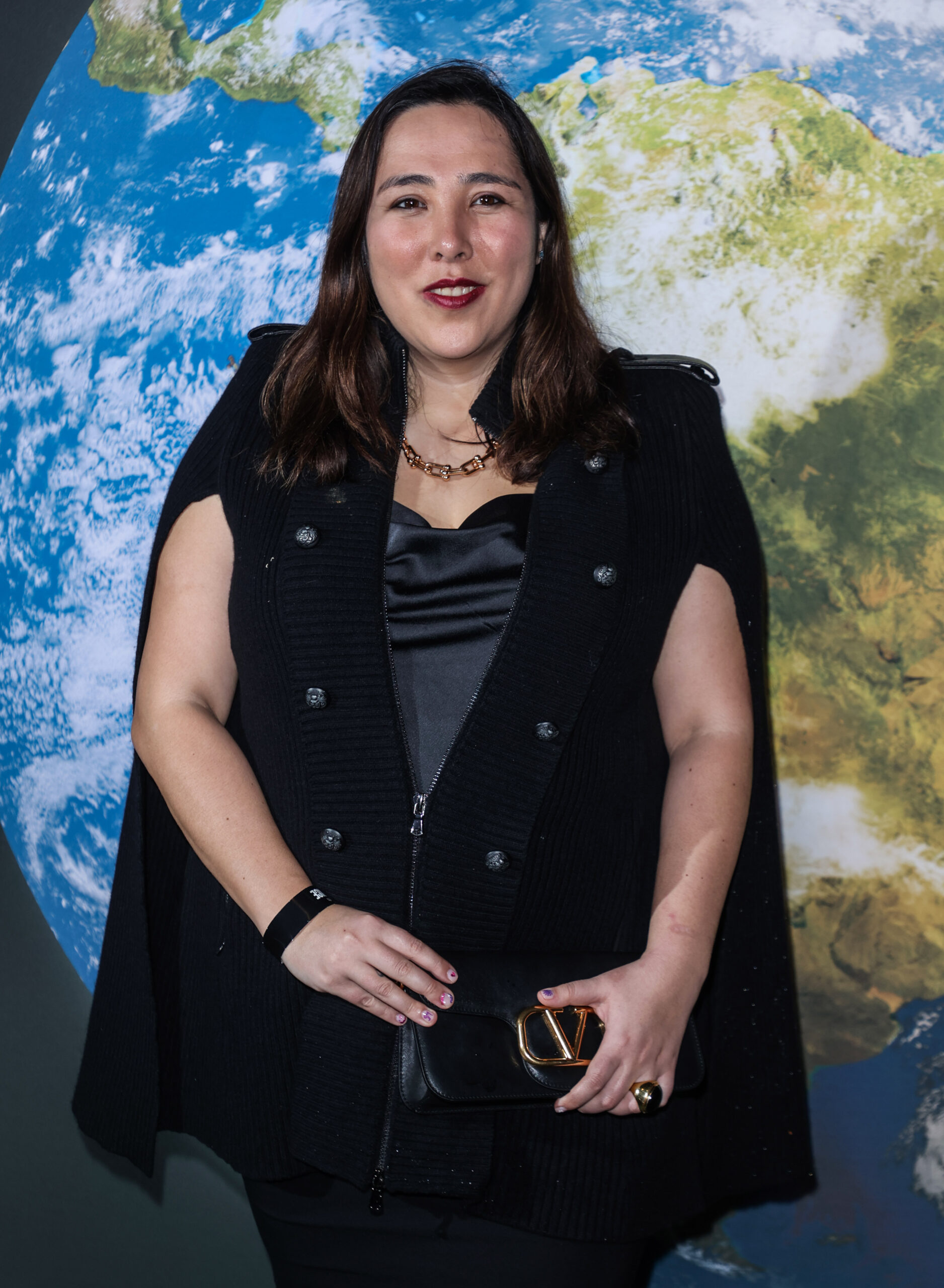 Michelle Elman standing in front of the earth