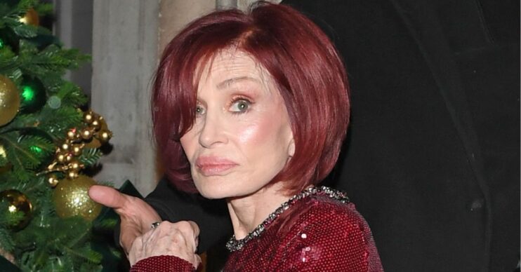 Sharon Osbourne looks worried in red dress
