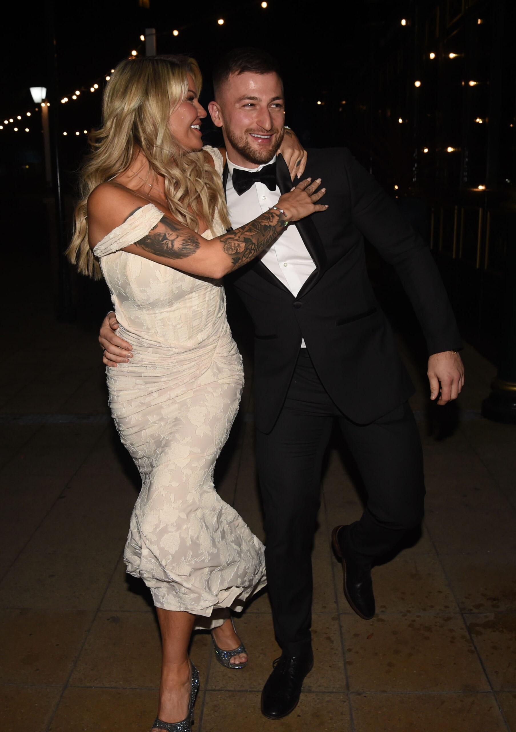 Kerry Katona embracing her new boyfriend Paolo Margaglione, as she wears a long lace dress and he wears a tuxedo