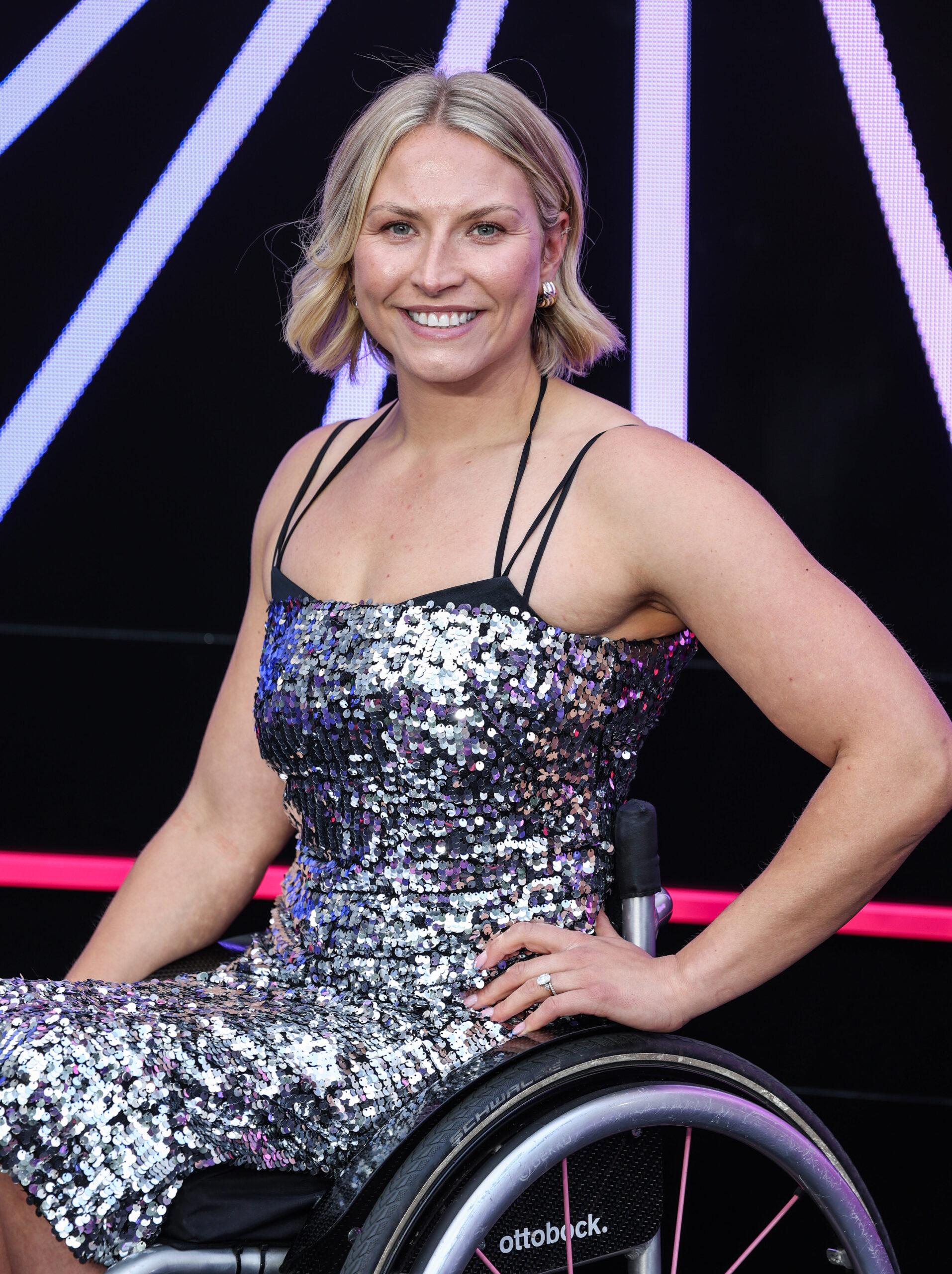 Sammi Kinghorn in a wheelchair and silver dress